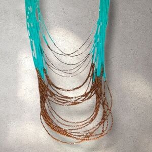 Stunning turquoise and bronze glass beaded 23 strand layered necklace